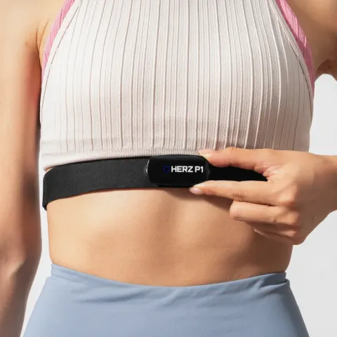 Woman adjusting the Herz P1 heart rate chest strap under her chest