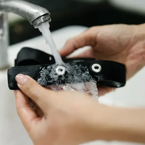 Herz P1 chest strap being rinsed under running water